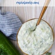 A bowl of creamy yogurt sauce with a spoon inserted, with a overlay that reads "easy homemade tzatziki, rachelcooks.com"