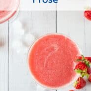 Overhead view of Frosé in a glass, with fresh strawberries also pictured..