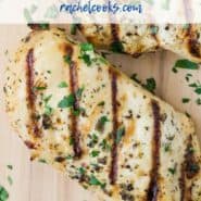 Grilled chicken breasts on a wooden cutting board. Text overlay reads "Easy Italian Chicken Marinade - rachelcooks.com"