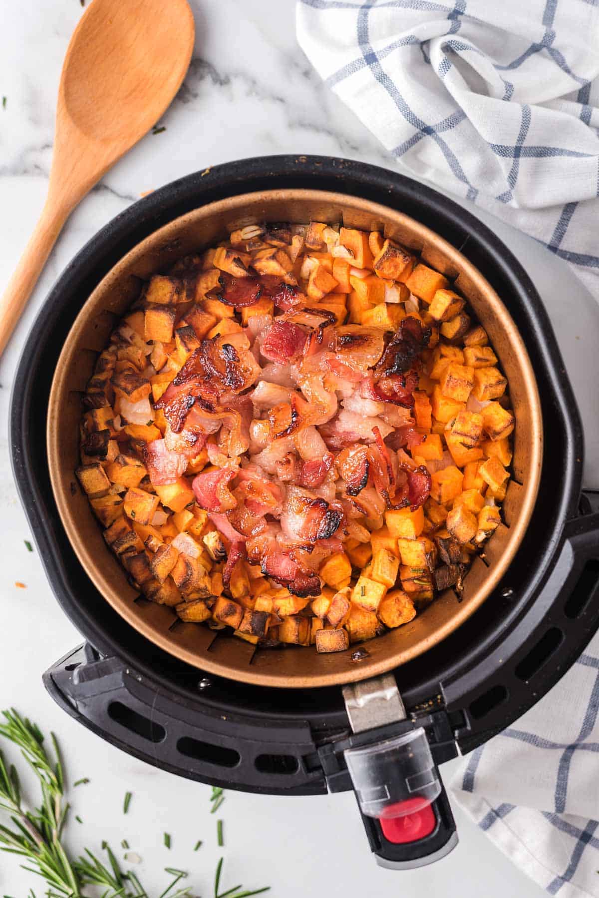 Sweet potato hash in the basket of an air fryer, overhead view.