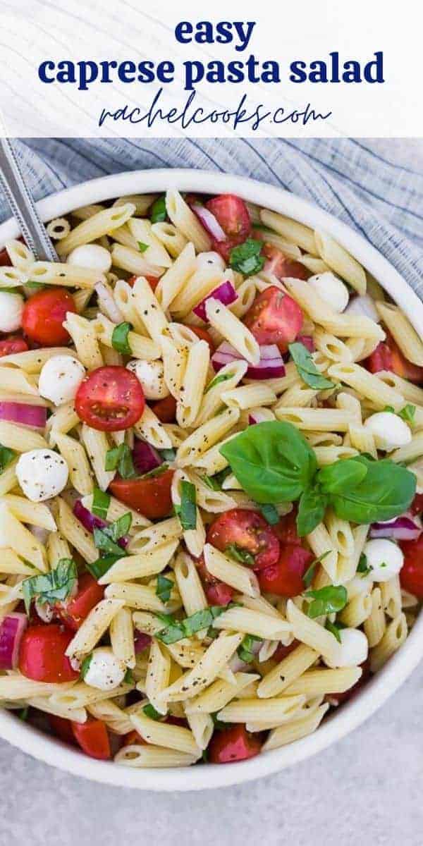 A white bowl full of pasta, fresh mozzarella, tomatoes, and fresh basil. A text overlay reads "the best caprese pasta salad."