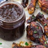 BBQ chicken drumsticks with a text overlay that reads "cherry chipotle bbq sauce."