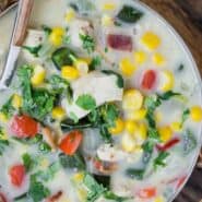 Overhead view of creamy soup in a bowl. Text overlay reads "chicken corn chowder"