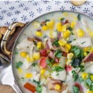 Overhead view of creamy soup in a bowl. Text overlay reads "healthy chicken corn chowder"