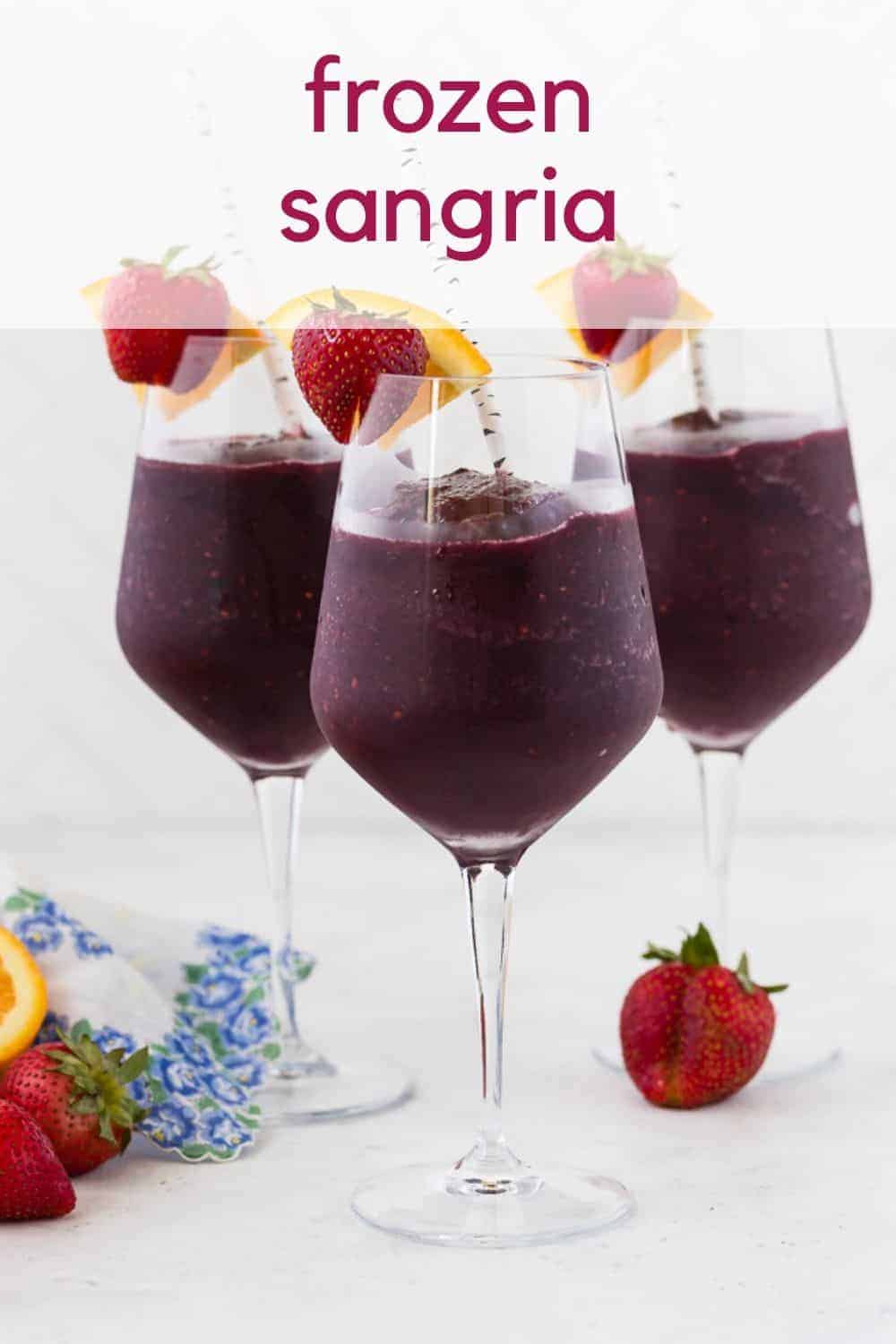 Three glasses of a dark red frozen beverage. Text overlay reads "frozen sangria."