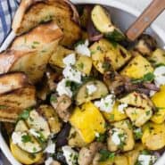 Overhead view of a warm vegetable salad, text overlay rads "grilled vegetable salad with goat cheese."