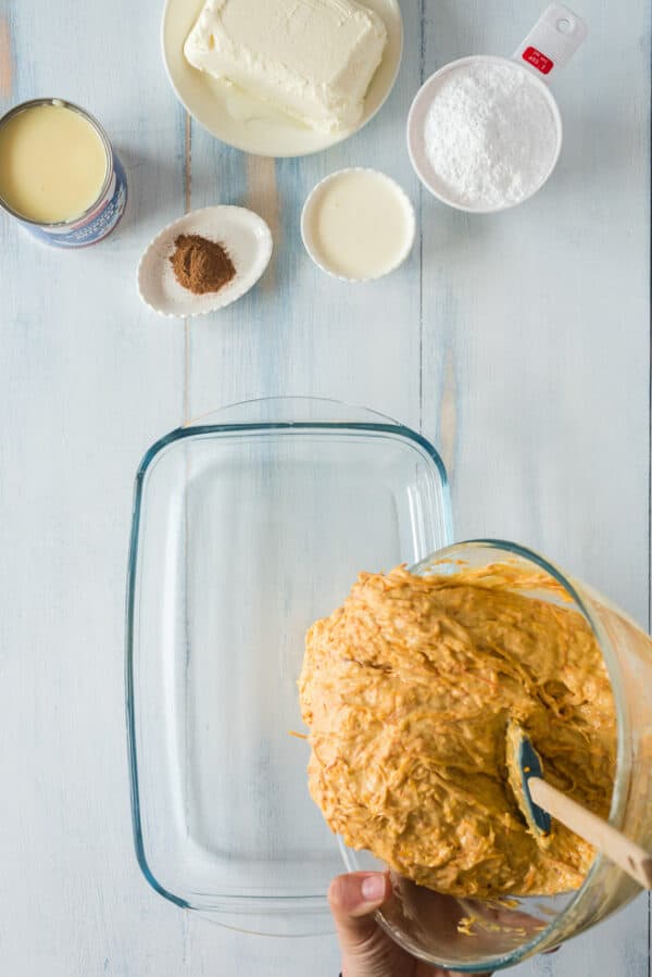 Pumpkin poke cake batter poured into a 9x13-inch cake pan.