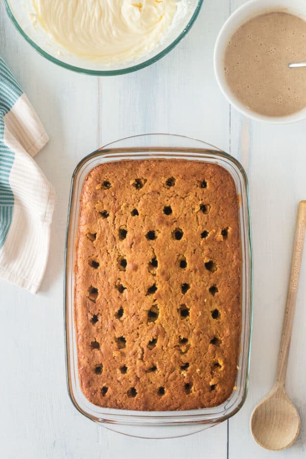 Pumpkin cake covered with holes on a countertop.