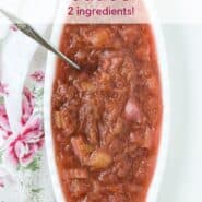 Overhead view of a light red sauce in a white oval bowl. Text overlay reads "rhubarb sauce - two ingredients!"