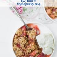 Close up view of strawberry rhubarb crisp and vanilla ice cream on a round plate, with a spoon.