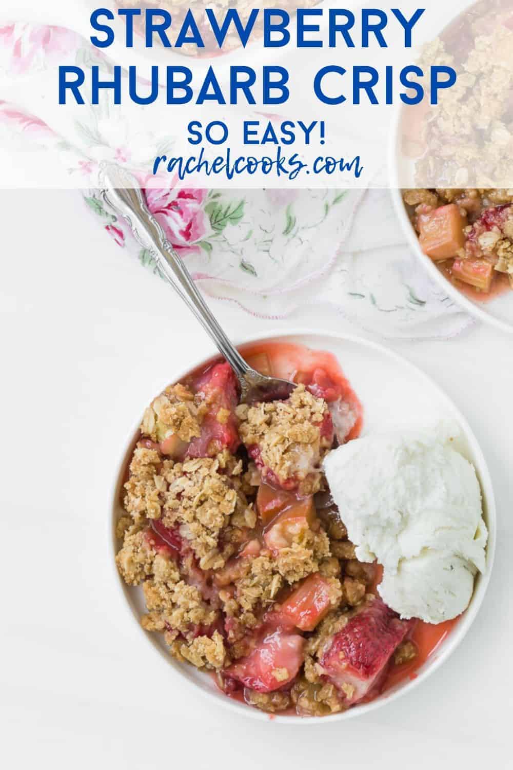 Close up view of strawberry rhubarb crisp and vanilla ice cream on a round plate, with a spoon.