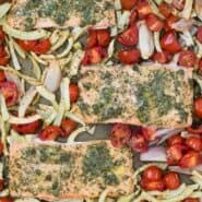 Overhead view of sheet pan dinner with text overlay that reads "sheet pan salmon with roasted fennel and tomatoes"