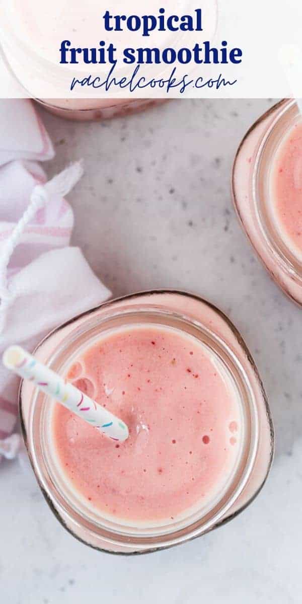 Overhead view of a pink fruit smoothie with fun sprinkles straws.