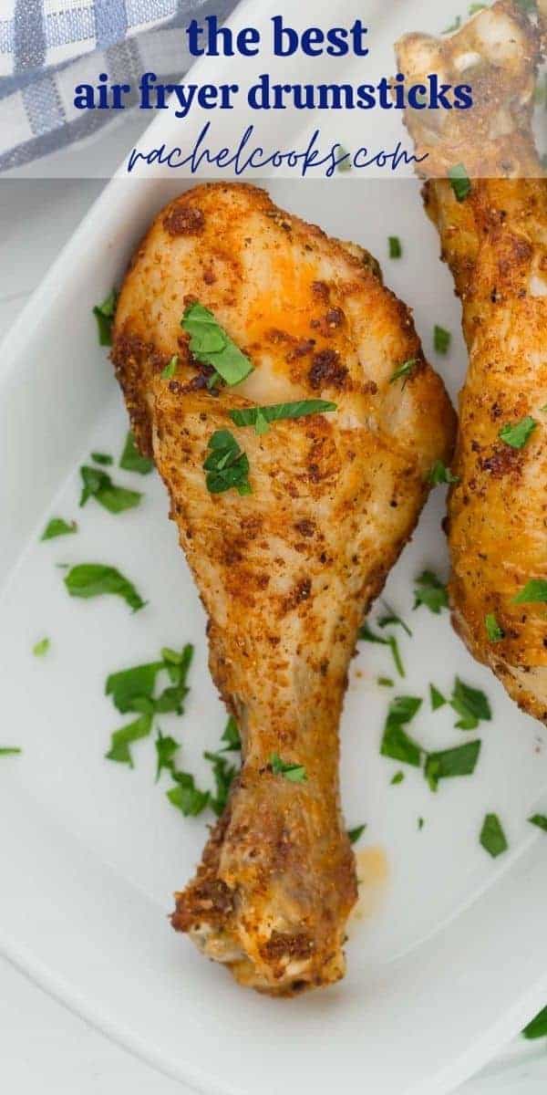 Chicken legs on a white plate, text overlay reads "easy air fryer chicken drumsticks"