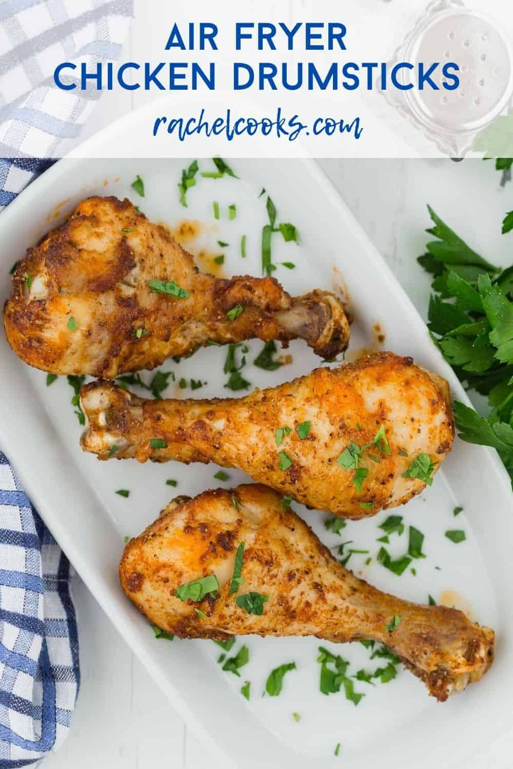 Chicken legs on a white plate, text overlay reads "easy air fryer chicken drumsticks - rachelcooks.com"