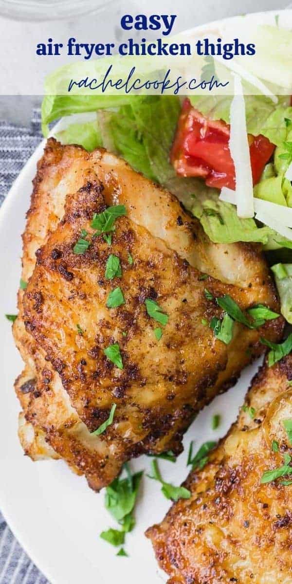 Two chicken thighs on a plate with salad, text overlay reads "air fryer chicken thighs, www.rachelcooks.com"