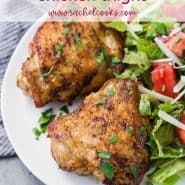 Two chicken thighs on a plate with salad, text overlay reads "air fryer chicken thighs, www.rachelcooks.com"