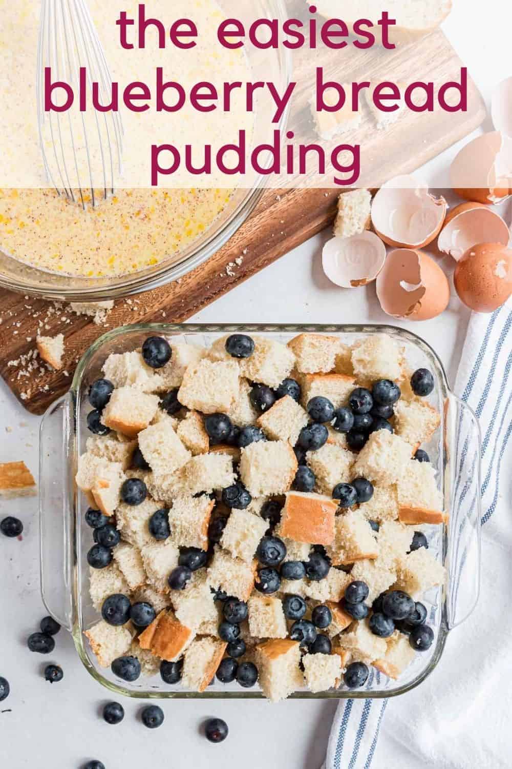 Overhead view of pan of uncooked blueberry bread pudding with text overlay that reads "the easiest blueberry bread pudding"