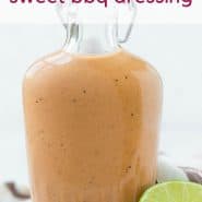 Small glass bottle of sweet bbq salad dressing on a wooden cutting board. Text overlay reads "sweet bbq dressing"