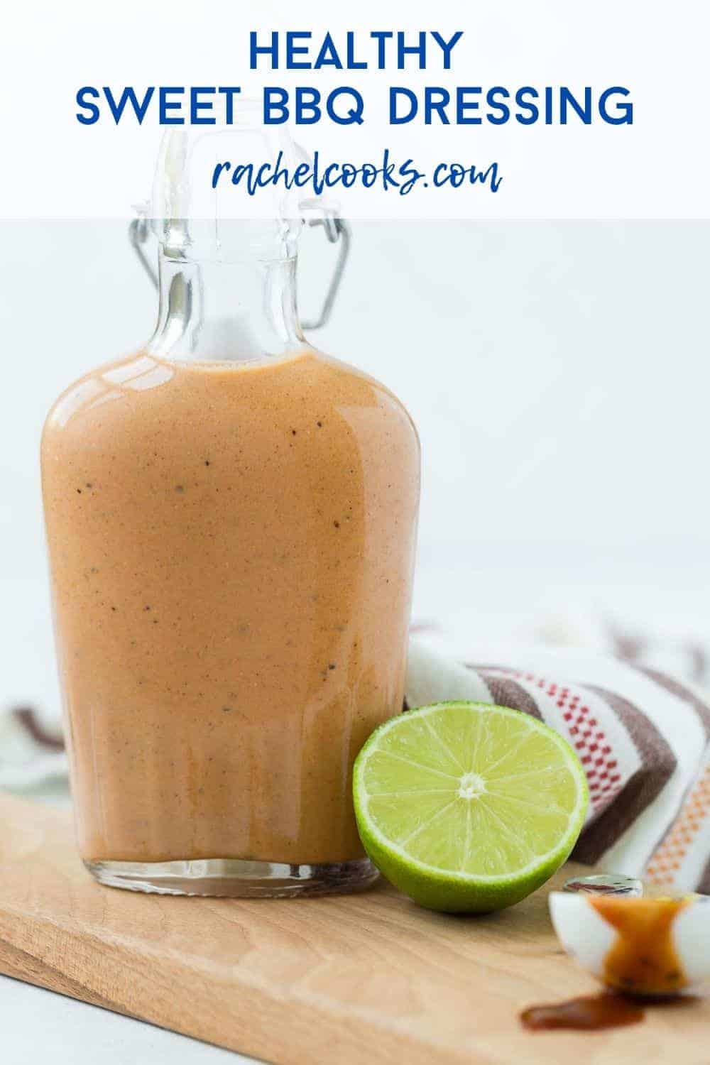 Small glass bottle of sweet bbq salad dressing on a wooden cutting board. Text overlay reads "healthy sweet bbq dressing"