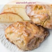 Two baked goods on a plate with apples, text overlay reads "air fryer apple fritters, rachelcooks.com"