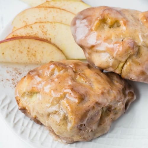Close up of two air fryer apple fritters with a glaze.