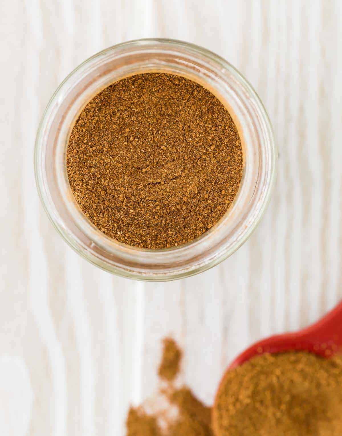 Overhead view of apple pie spice mix in a jar.
