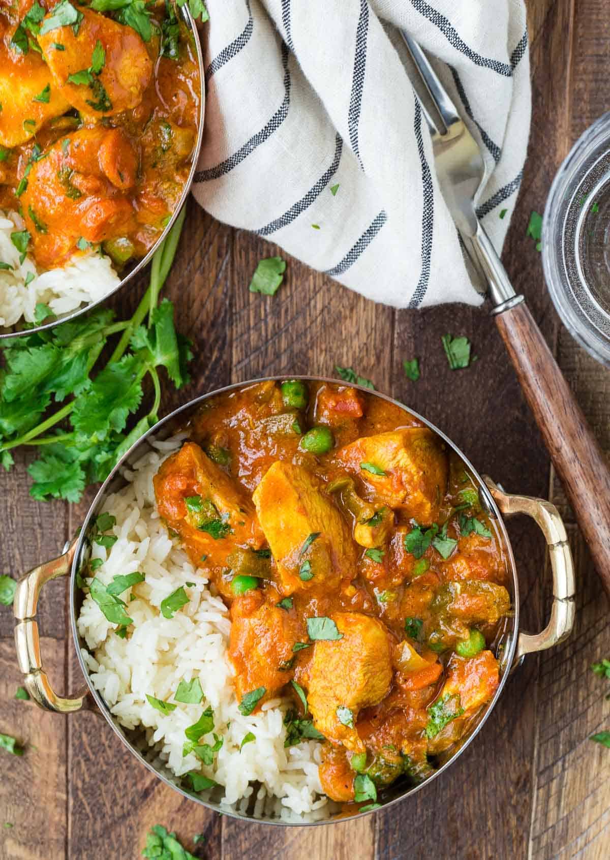 Overhead view of chicken tikka masala served in a bowl with rice.