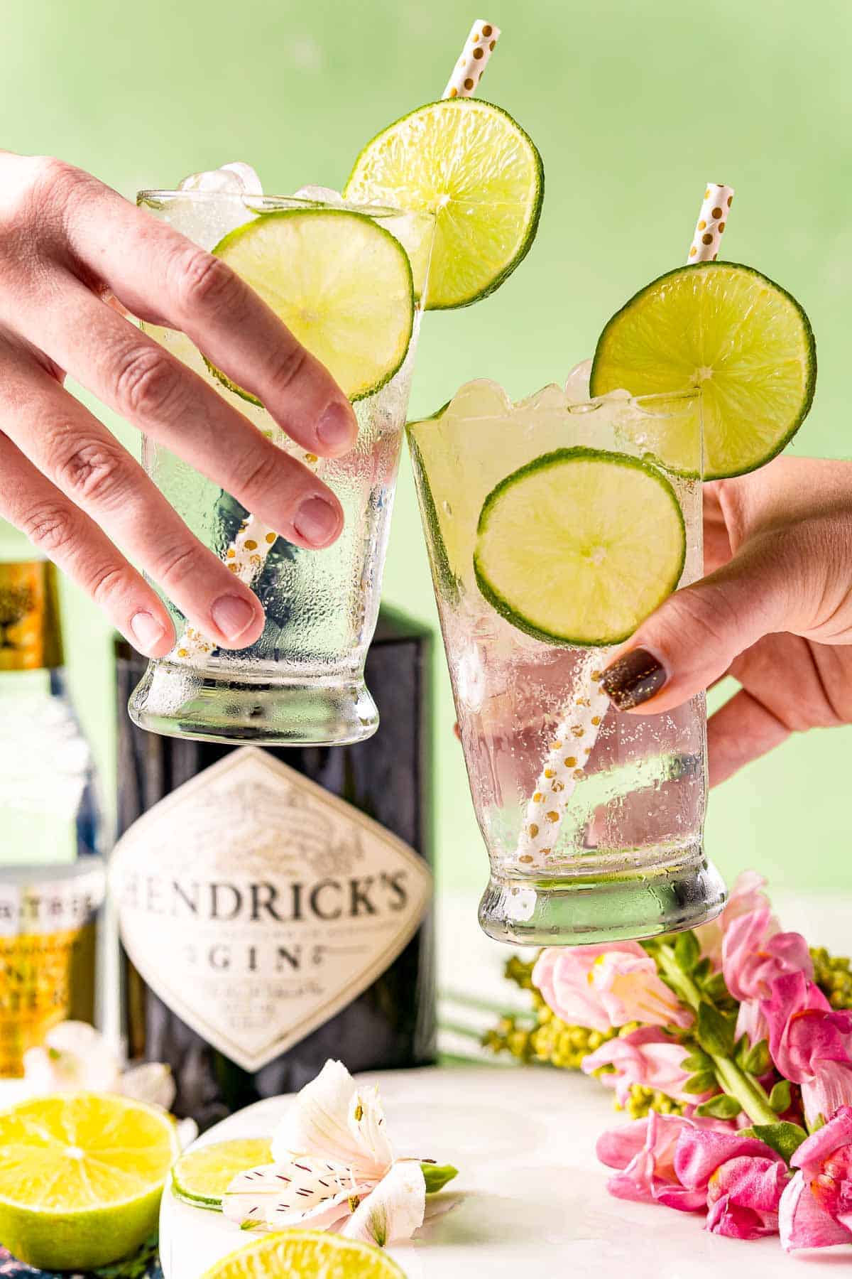 Two cocktail glasses being clinked together in a "cheers."