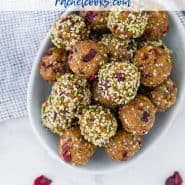 Overhead view of a bowl of energy bites, text overlay reads "cranberry oatmeal energy balls - nut free - rachelcooks.com"
