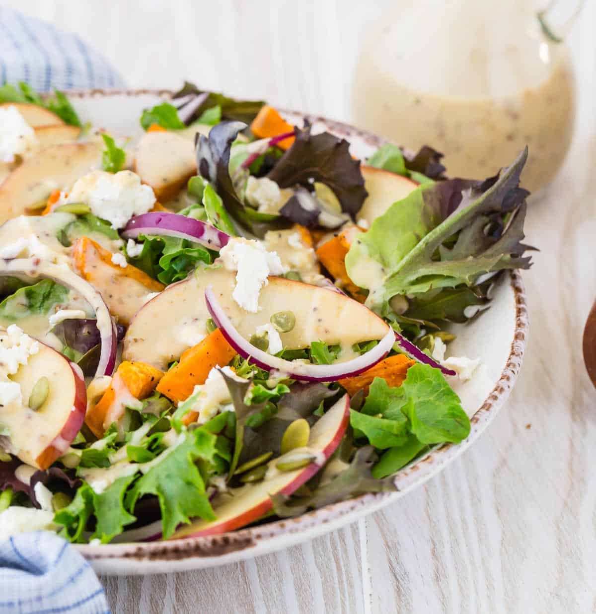 Colorful salad with creamy white dressing.