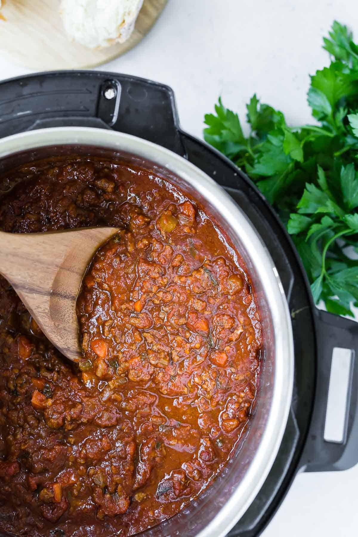 Overhead view of an Instant Pot pressure cooker full of bolognese sauce.