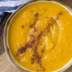 Overhead view of a bowl of kabocha squash soup.