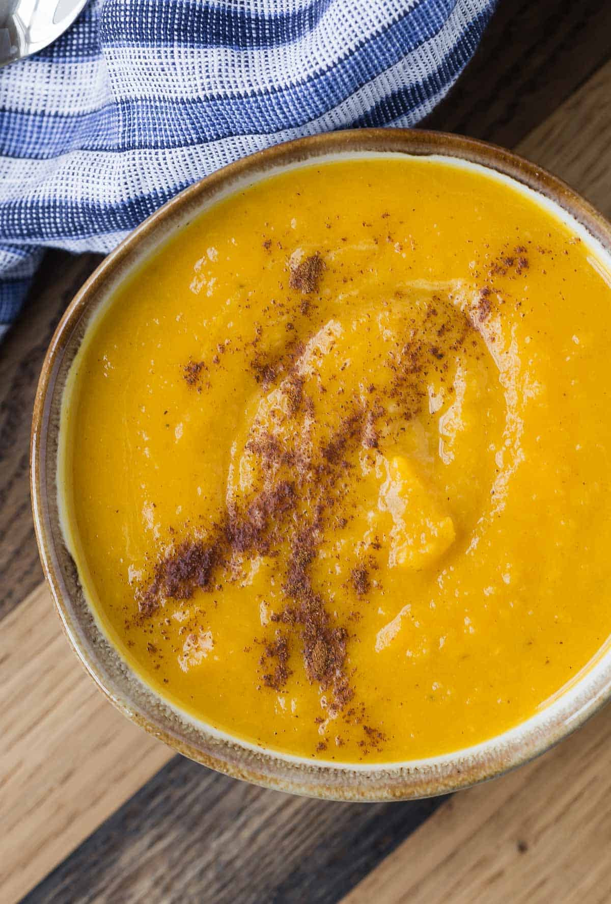 Overhead view of a bowl of kabocha squash soup.