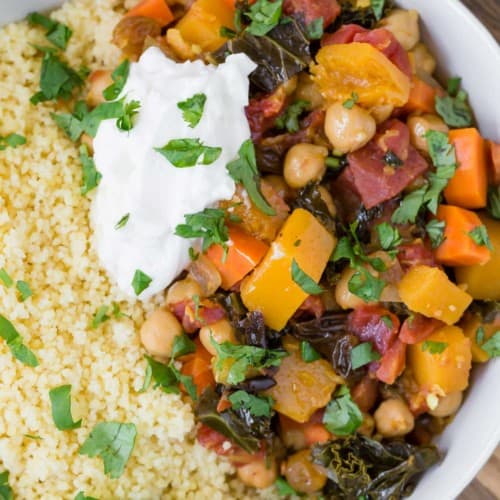 Close up overhead view of moroccan stew made with butternut squash, chickpeas and more. Served with couscous.
