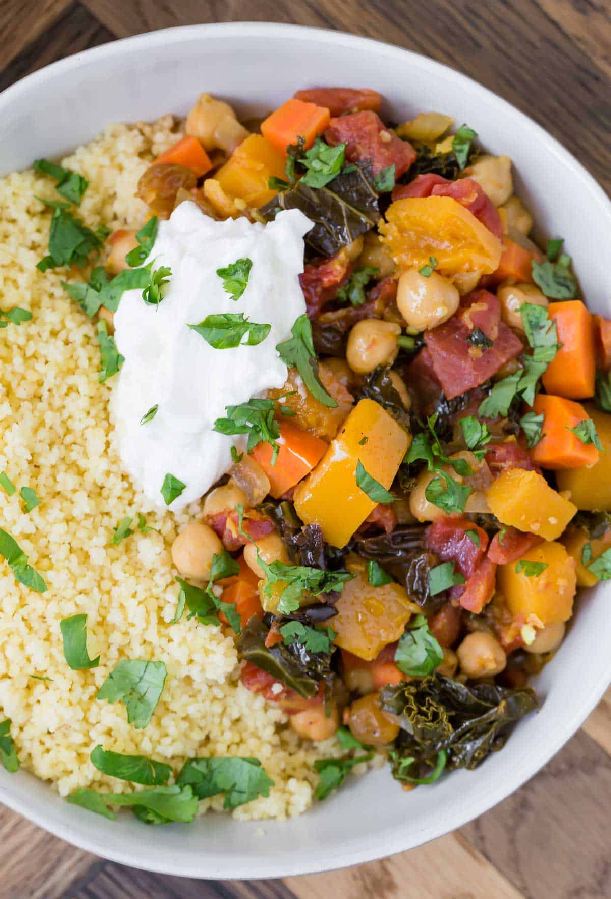 Close up overhead view of moroccan stew made with butternut squash, chickpeas and more. Served with couscous.
