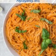 Overhead view of pasta in a bowl, text overlay reads "angel hair pasta and roasted red pepper sauce, rachelcooks.com"