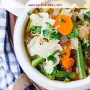 Colorful soup in a white bowl, text overlay reads "amazingly healthy vegetable soup, rachelcooks.com"