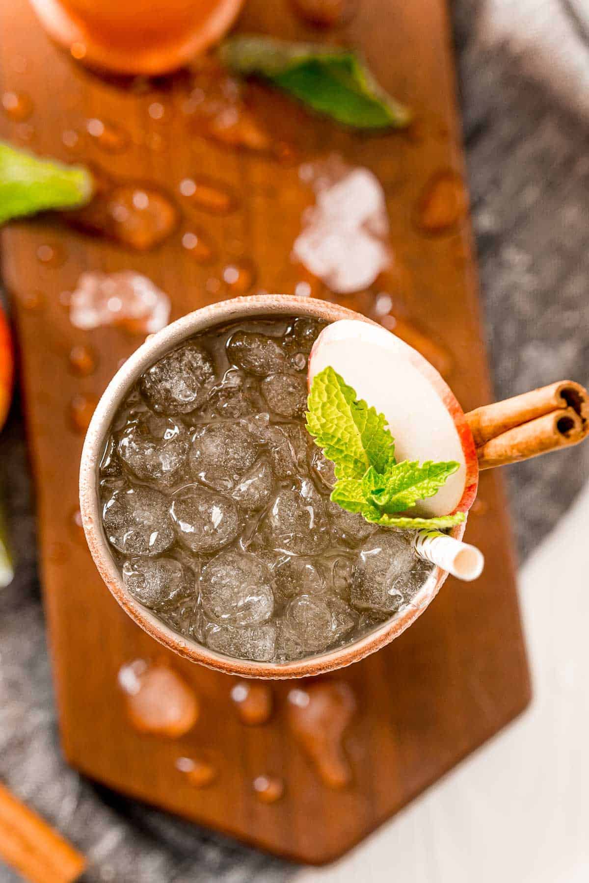 Overhead view of an apple cider mule served in a copper cup.