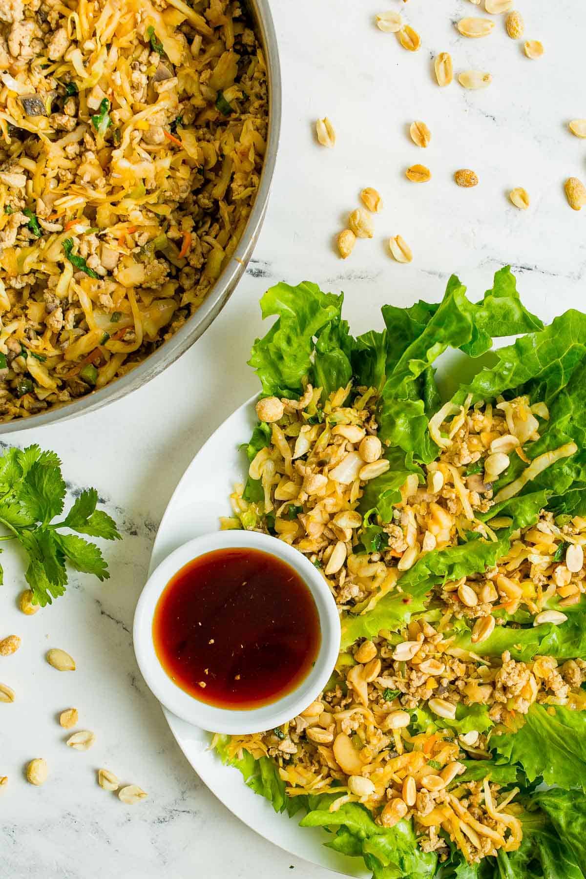 Chicken lettuce wraps on a plate and in a pan.