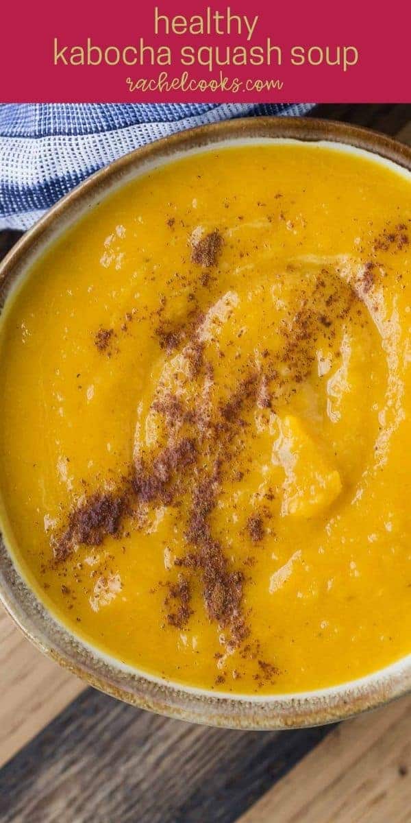 Bowl of orange colored soup, text overlay reads "healthy kabocha squash soup"