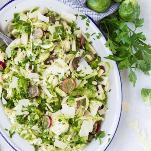 Overhead view of Brussels sprouts salad on a large platter.