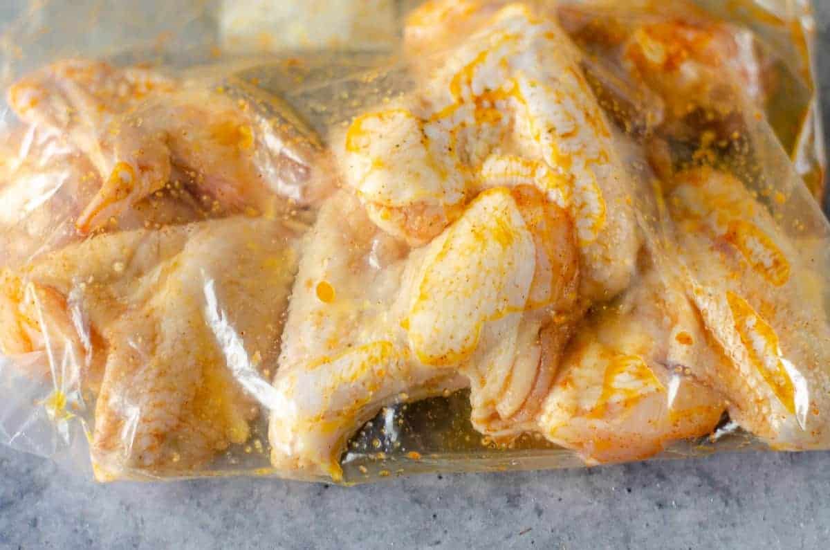 Uncooked wings in a zip-top bag.