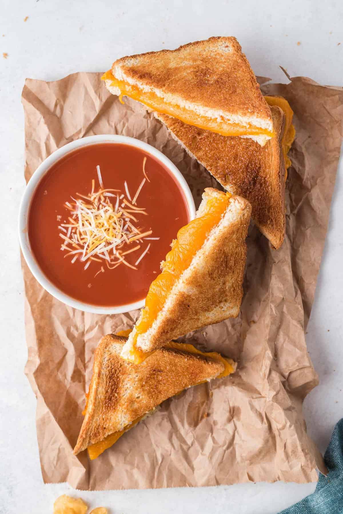 Grilled cheese sandwich halves, and tomato soup