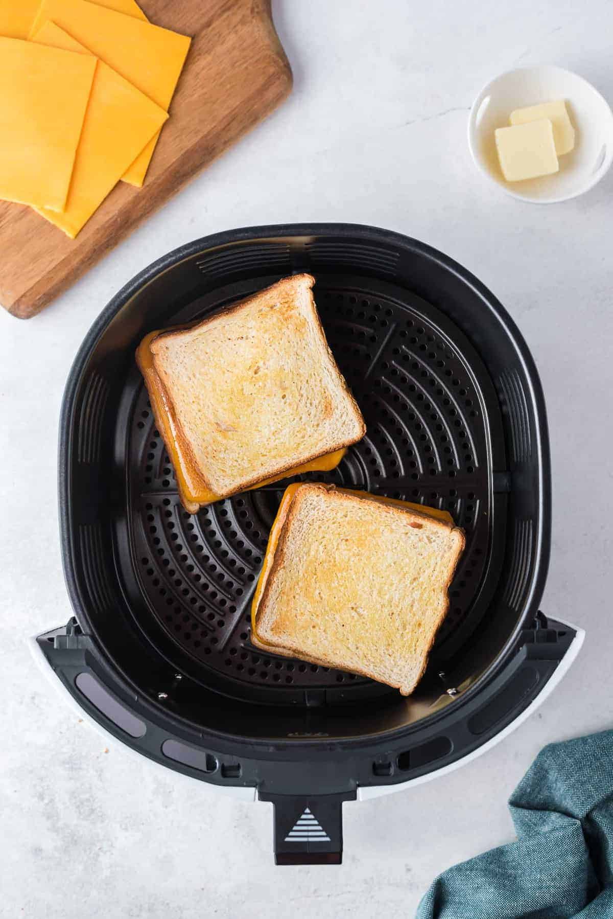 Grilled cheese being made in an air fryer.