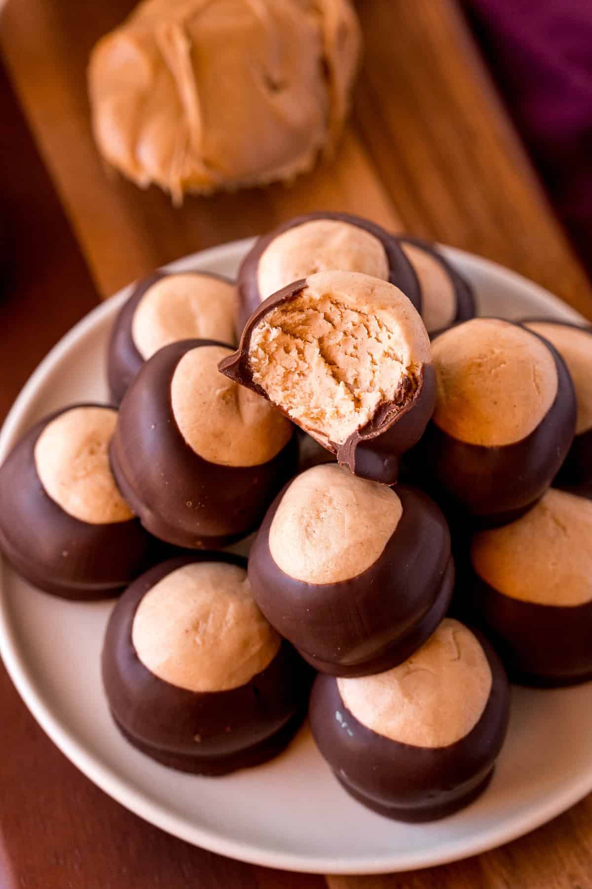 A pile of chocolate and peanut butter candies, the top with a bite removed.