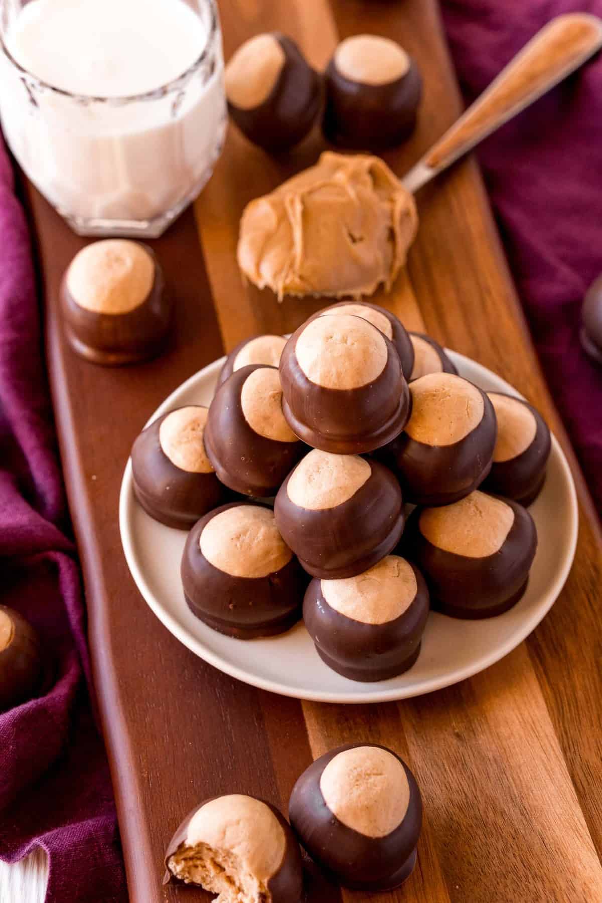 Buckeyes on a plate, ingredients in the background.