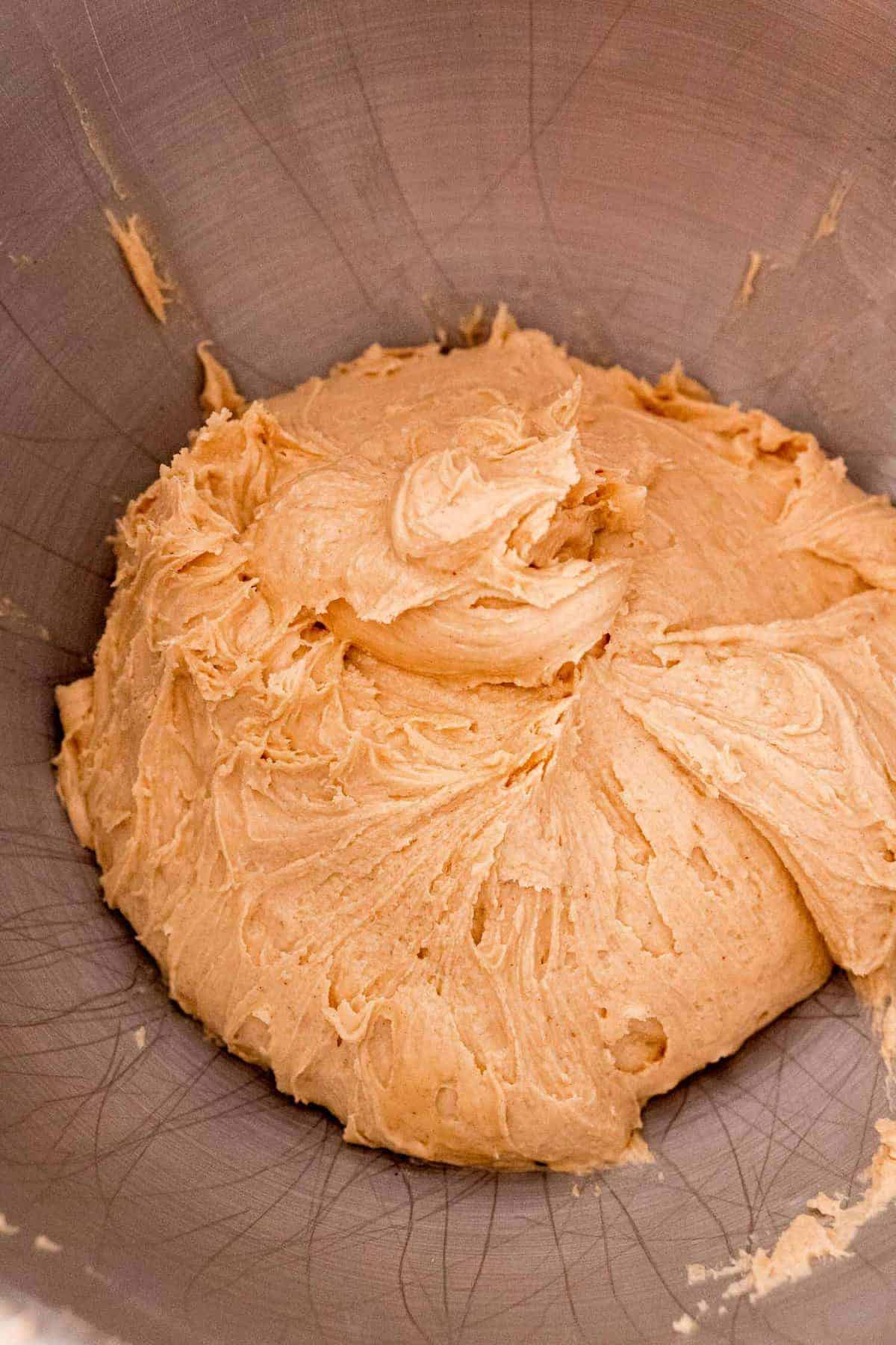 Peanut butter mixture in a metal bowl.