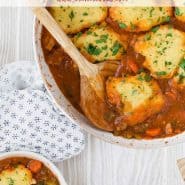 Overhead view of chicken with dumplings, text overlay reads "one pan chicken with cornmeal dumplings"