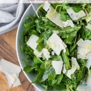 Overhead view of an arugula salad with a text overlay that reads "the best classic arugula salad, rachelcooks.com"